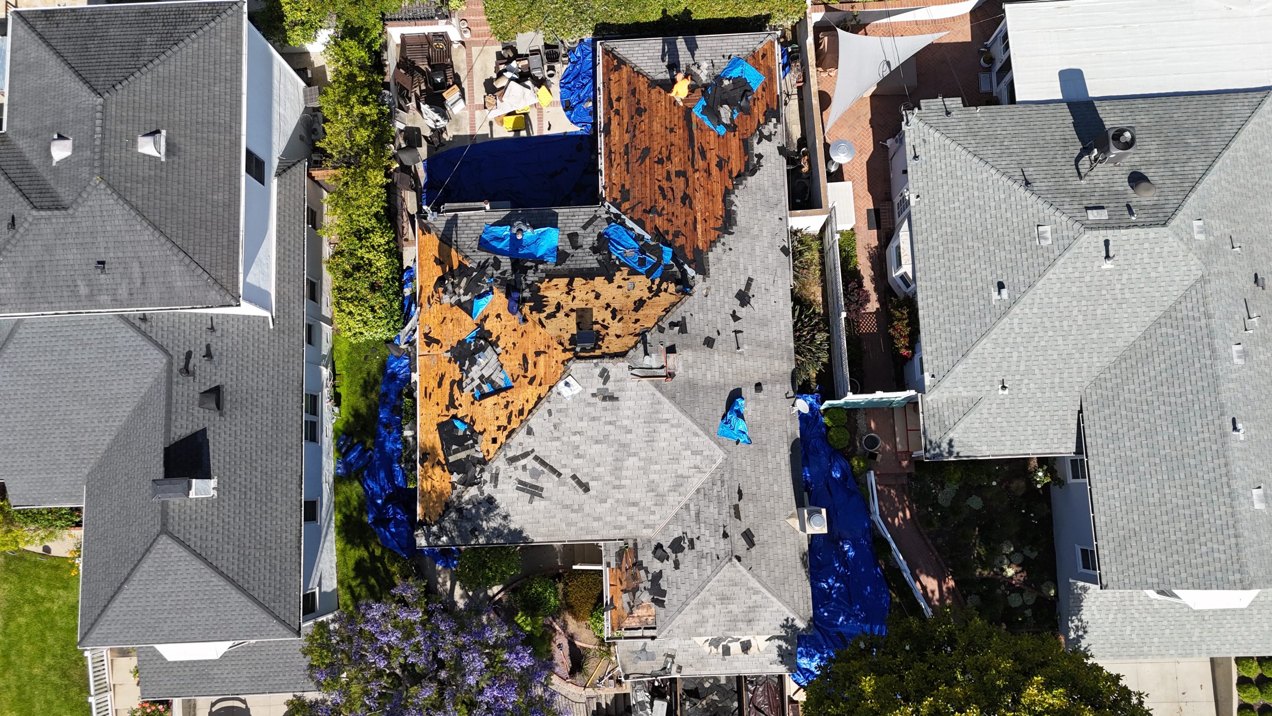 Roofer tracing a leak back to its entry point on a Los Angeles roof